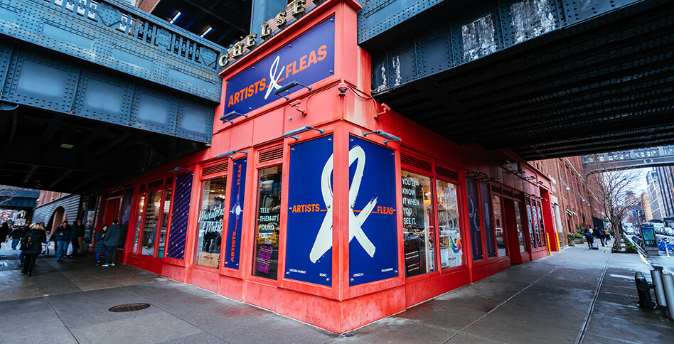 Exterior of Artists & Fleas Chelsea Market with red wall and purple logo